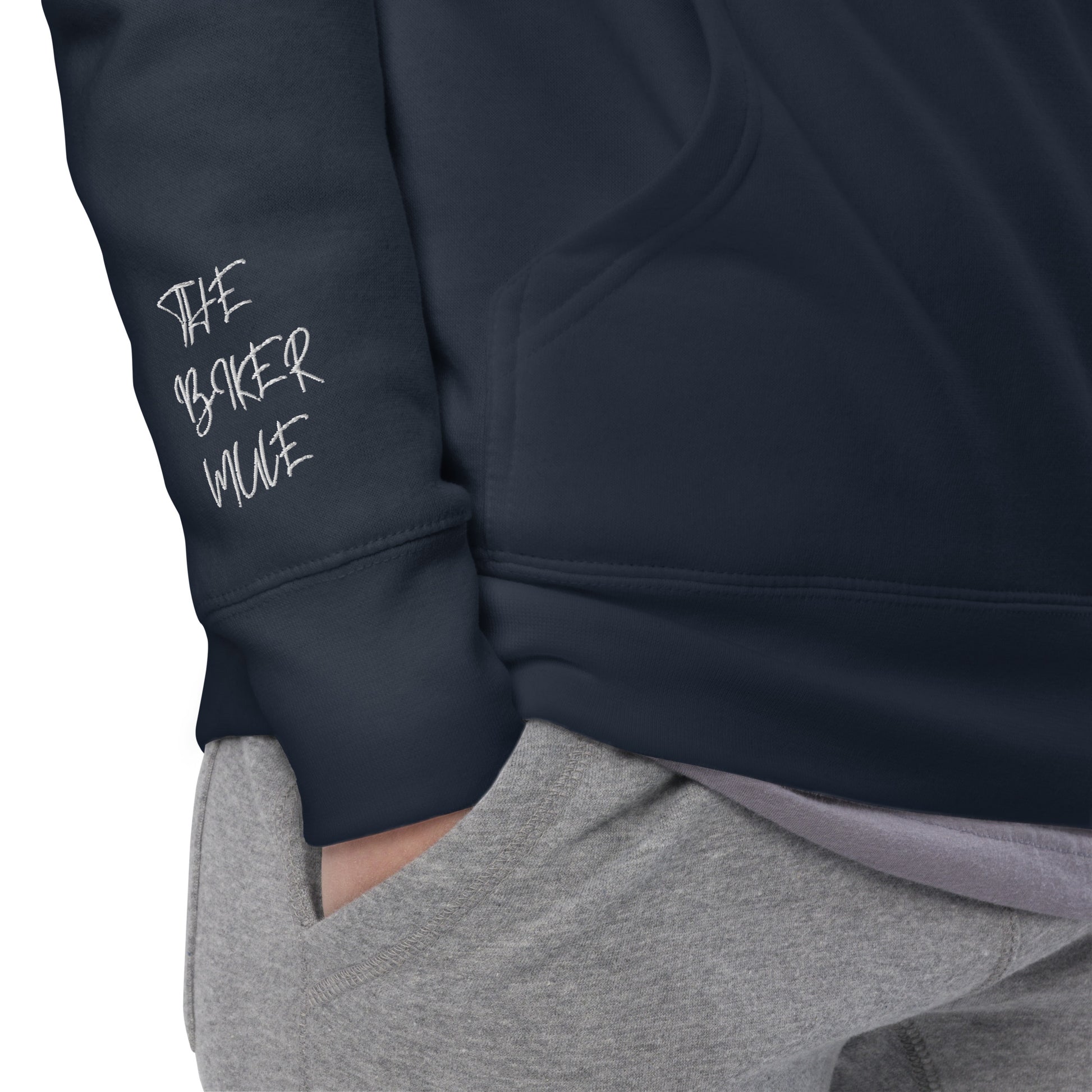The Biker Mule navy motorcycle style hoodie sleeve with white logo detail and hand in grey pants pocket
