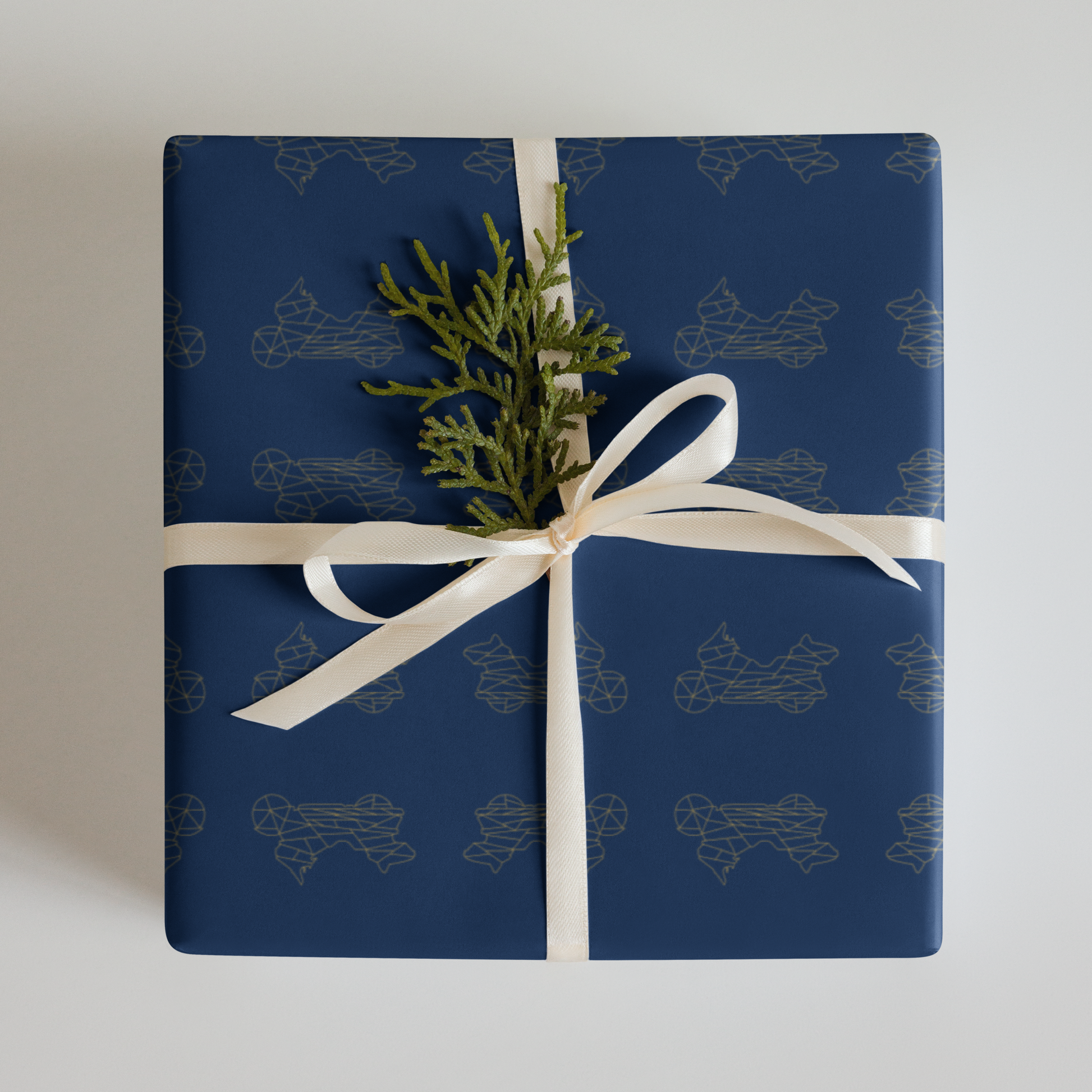 Stylish blue motorcycle gift wrapping paper featuring a subtle motorcycle design with a ribbon and greenery decoration