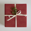 Motorcycle gift wrapping paper featuring a red background with gold motorcycle designs, topped with a festive ribbon
